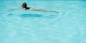 swimmer in pool at sunset